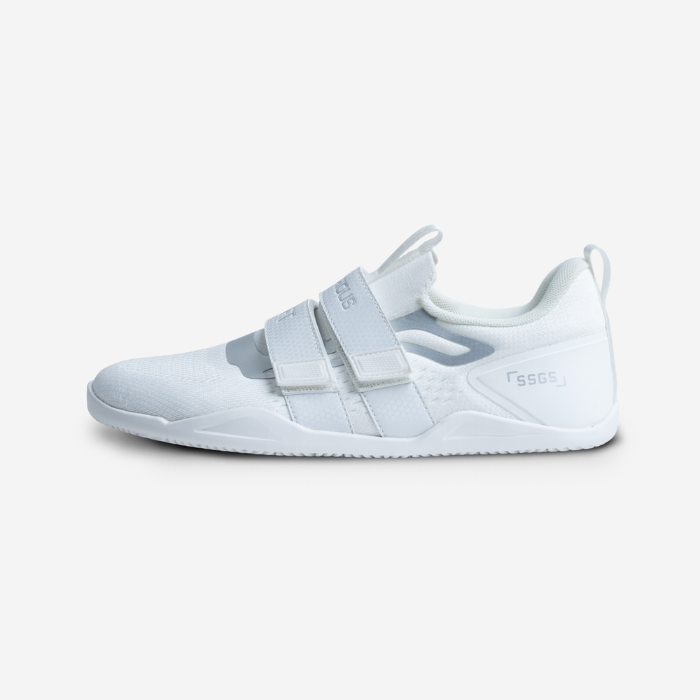 White athletic shoe with velcro straps on a light gray background