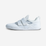 White athletic shoe with velcro straps on a light gray background