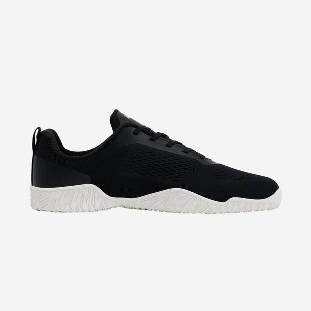 Black athletic shoe with white sole on a light gray background